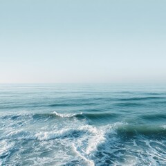 Fototapeta premium Calm ocean waves meet a clear sky