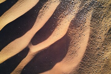 Obraz premium Aerial view of brown sandy beach texture.