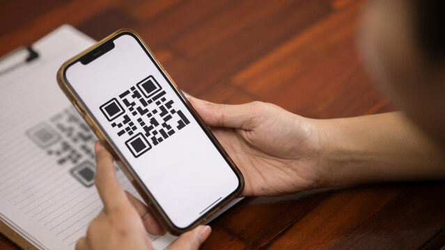 Hand Holding Smartphone Scanning QR Code for Digital Payment and Access