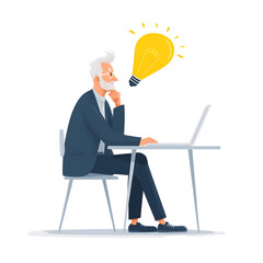 Senior business man having a great idea while working on his laptop at his office