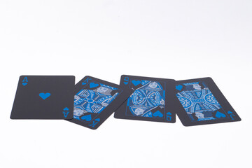 Four Playing Cards with Blue Floral Designs on a White Background, Close-Up.