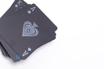Stack of Black Playing Cards Featuring Ace and King of Spades on White Background.