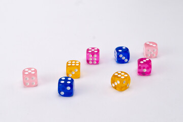Colorful Dice Arrangement on White Background - Pink, Blue, and Yellow Translucent Cubes with White Dots.