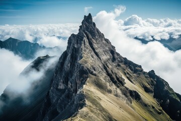 Jagged mountain peak piercing through clouds rock stone