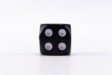 Black Dice with Four Spots on White Background, Game of Chance, Single Object.