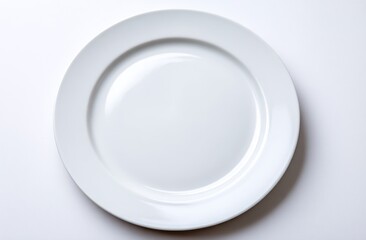 Plain white, round ceramic plate sitting centered on a bright white surface, casting gentle shadows