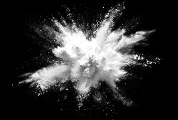 A burst of fine, white powder explodes outwards against a stark black background, creating a dynamic and abstract cloud-like formation
