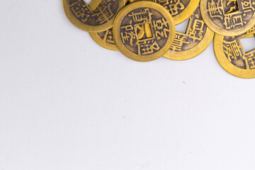 Pile of Antique Chinese Coins with Square Holes on White Background, Close-Up.