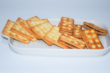 A biscuit is a flour-based baked food item. Biscuits are typically hard, flat, and unleavened. They are usually sweet and may be made with sugar, chocolate, icing, jam, ginger, or cinnamon. 