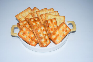 A biscuit is a flour-based baked food item. Biscuits are typically hard, flat, and unleavened. They are usually sweet and may be made with sugar, chocolate, icing, jam, ginger, or cinnamon. 