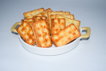 A biscuit is a flour-based baked food item. Biscuits are typically hard, flat, and unleavened. They are usually sweet and may be made with sugar, chocolate, icing, jam, ginger, or cinnamon. 