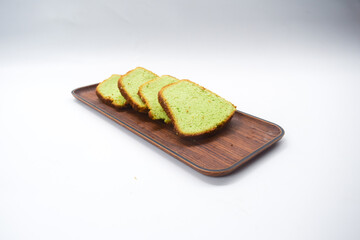 Kue bolu or simply bolu is an Indonesian term that describes a wide variety of sponge cakes, tarts and cupcakes. Green sponge cake with white background