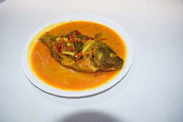 Ikan Nila bumbu kuning, Traditional Menu from West Indonesia, Made from Fried Tilapia and yellow sauce made from turmeric