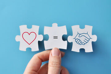 Symbolic puzzle photo with heart and house connected by equality sign. Concept of family, love, home, relationships and emotional support.