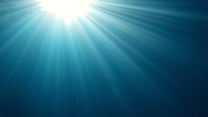 Sunlight streams through ocean waves, creating a mesmerizing play of light and shadow in deep blue waters.