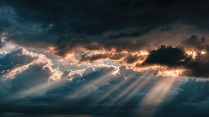 A dramatic sky filled with dark clouds and rays of sunlight breaking through, creating a striking contrast and an atmospheric scene.