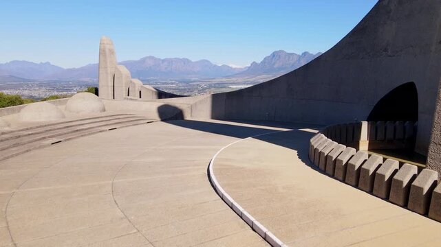 Low aerial at symbolic Afrikaans language monument overlooking Paarl and farm lands of Stellenbosch in Western Cape South Africa