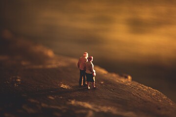 Miniature Figures of Elderly Couple Contemplating an Uncertain Future Landscape