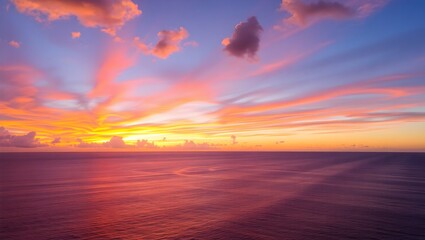 Fototapeta premium Vibrant panoramic sunset over calm ocean waters with orange pink and purple sky reflecting on tranquil sea