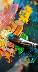 Obraz premium Close-up of a paintbrush mixing vibrant colors on a palette, showcasing artistic creativity