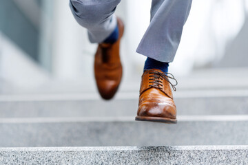 Businessman running upstairs symbolizing success