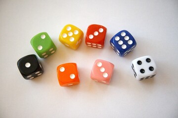 Group of multicolored dice arranged on a white background with copy space.