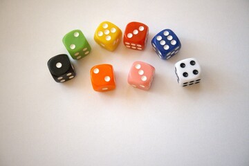 Group of multicolored dice arranged on a white background with copy space.