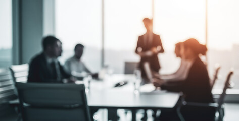Blurred business meeting with diverse people around a table in a bright office, showing collaboration, engagement, and teamwork in a creative professional environment full of energy.