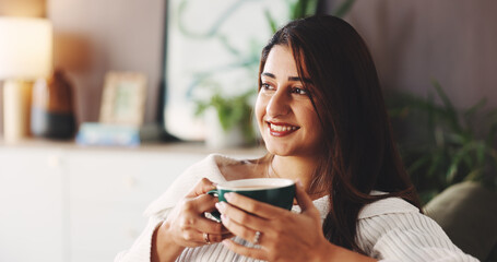 Relax, coffee and woman on couch with smile, inspiration and daydreaming in home. House, morning and female person in living room with reflection, warm beverage and thoughtful on weekend break