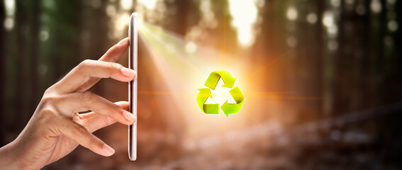 "Smartphone with green forest background, concept of helping technology and environmental conservation"Green recycling arrow symbo
