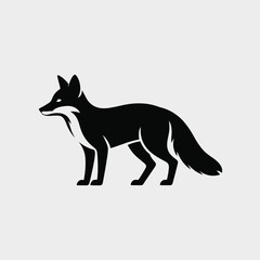 Fototapeta premium Black fox silhouette standing alert on a light gray background white animal