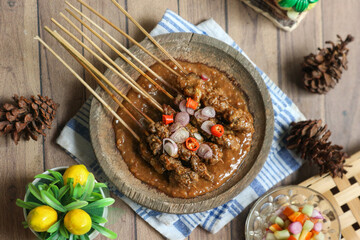 Sate kambing or satay kambing, a beloved Indonesian goat meat skewer often enjoyed during Idul Adha, features charcoal-grilled meat paired with a rich peanut sauce.