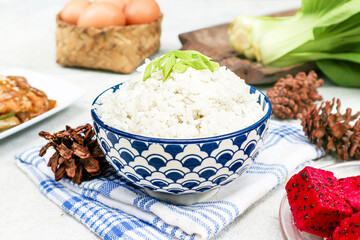 It’s a bowl of fluffy white rice, topped with a sprinkle of chopped leek. This is considered a staple food in many Asian countries.