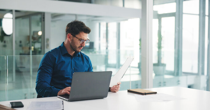 Laptop, reading and documents with business man in office for research, payroll manager and audit report. Planning, budget review and accounting firm with person in agency for tax benefit and email - Powered by Adobe