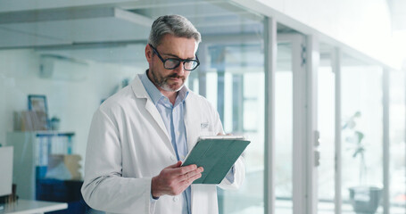 Reading, tablet and glasses with doctor in hospital for healthcare report, research grant and planning. Medical case review, clinical guidelines and telehealth app with mature person for insurance