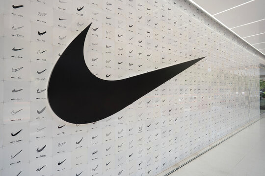 Shanghai, China - July 15, 2025: Nike logo and hand-drawn Swoosh patterns created by Nike members and local artists are seen on the exterior wall of the Nike Style retail concept store in Shanghai.