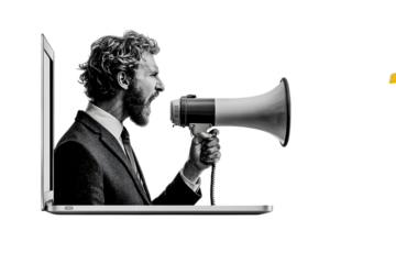 Businessman shouting in megaphone from laptop. Online marketing.
