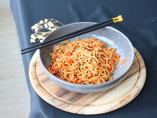 Stir-fried instant noodles with vegetables and meat, a quick and flavorful Thai comfort food dish loved for its savory taste.