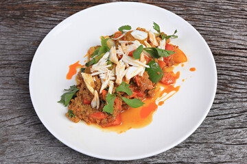 Stir-fried crab meat with curry powder decorates the top with steamed crab meat on white plate