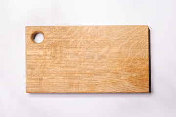 Empty cutting board on a white background with leaf shadows