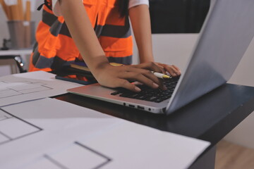 Closeup of team of industrial engineers meeting analyze machinery blueprints consult project on...