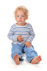 A cute and funny blue-eyed baby dressed in jeans