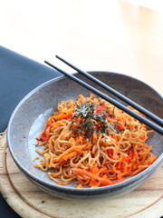 Stir-fried instant noodles with vegetables and meat, a quick and flavorful Thai comfort food dish loved for its savory taste.