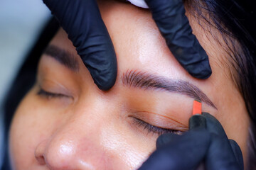 Eyebrow tattoo artist.