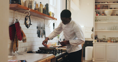 Private chef, man and frying steak in house for meal prep, searing process or custom dinner menu. Culinary skill, black person or grill beef in home kitchen for healthy dish, nutrition or meat recipe