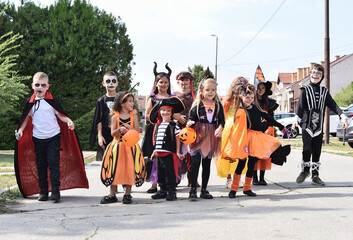 Children walking in the city picking up candy on Halloween