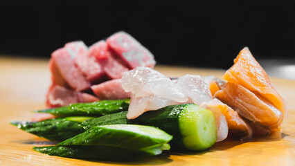 Sashimi on a wooden surface served on a Kyōto sushi bar. 