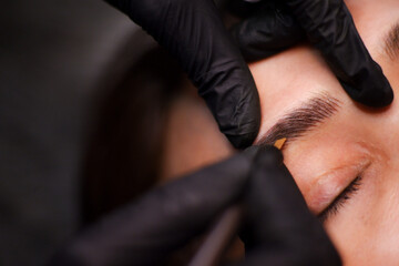 Eyebrow tattoo artist.