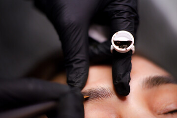 Eyebrow tattoo artist.