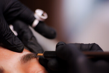 Eyebrow tattoo artist.